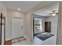 Welcoming entryway with adjacent sitting room featuring natural light and modern decor at 13234 Great Plains Dr, Riverview, FL 33579