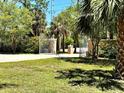 Landscaped view of the property's ornate gated entrance, offering privacy and curb appeal at 1516 Bayshore Blvd, Dunedin, FL 34698
