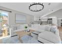 Cozy living room with an open layout, a modern chandelier, and comfortable seating at 19 Crescent S Pl, St Petersburg, FL 33711