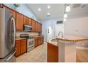 Modern kitchen with stainless steel appliances, granite countertops, ample cabinetry, and tile flooring at 211 Royal Bonnet Dr, Apollo Beach, FL 33572