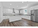 Spacious kitchen featuring white cabinets, stainless steel appliances, granite countertops and large island at 3612 W Pearl Ave, Tampa, FL 33611