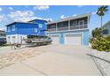 Charming two-story home with a two-car garage and a boat on a trailer in the driveway at 4039 Casa Ct, Hernando Beach, FL 34607