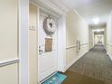 Condo hallway with carpeting, doors, trim, and lighting, for a well-maintained and inviting atmosphere at 4516 Seagull Dr # 903, New Port Richey, FL 34652