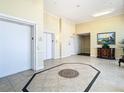 Condo lobby with a tiled floor, elevators, and an elegant painting, offering a welcoming entrance at 4516 Seagull Dr # 903, New Port Richey, FL 34652