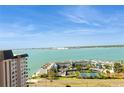 High-angle view of a beautiful coastal complex with a tennis court and water views against a clear sky at 5200 Brittany S Dr # 1807, St Petersburg, FL 33715