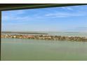 A stunning waterfront view through a window overlooking waterfront homes, and scenic waterways at 5200 Brittany S Dr # 1807, St Petersburg, FL 33715
