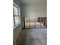 Spacious living room renovation featuring a large window that lets in natural light and exposed wall studs at 5312 Berkley Rd, New Port Richey, FL 34652