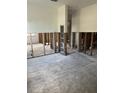 Open-concept living room under construction with exposed studs, providing a blank canvas for customization at 5312 Berkley Rd, New Port Richey, FL 34652