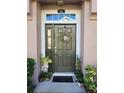 Inviting front door with wreath, sidelight, transom window and decorative plants at 584 52Nd N Ave, St Petersburg, FL 33703