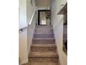 Carpeted staircase with white railing and decorative mirror leading to upper level at 584 52Nd N Ave, St Petersburg, FL 33703