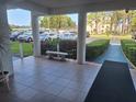 Building entrance featuring tile flooring, a bench, and well-maintained landscaping at 5970 80Th N St # 312, St Petersburg, FL 33709