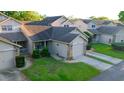 Aerial view of a cozy townhouse in a residential neighborhood with mature trees and well-kept lawns at 6516 Remus Dr, New Port Richey, FL 34653