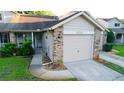 Charming townhouse with a well-maintained lawn, front patio, and attached one car garage at 6516 Remus Dr, New Port Richey, FL 34653
