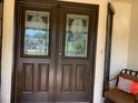 Elegant double front doors featuring decorative glass panels and a classic design at 776 Lakewood Dr, Palm Harbor, FL 34684