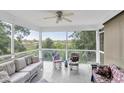 Relaxing screened patio featuring comfortable wicker furniture and serene outdoor views at 9520 Indale Dr, New Port Richey, FL 34654