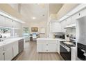 Well-lit kitchen offering ample counter space, modern appliances, and views of the pool area and home office at 10021 Elgin Blvd, Spring Hill, FL 34608