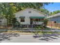 Traditional home exterior features a fenced yard, and a welcoming front entrance at 1205 E Emma St, Tampa, FL 33603