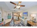 Cozy living room with stylish decor, comfortable seating, and a ceiling fan at 1211 Golfview Woods Dr, Sun City Center, FL 33573