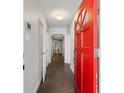 Bright foyer featuring tiled floors and a striking red front door at 1222 E Powhatan Ave, Tampa, FL 33604
