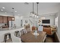 Spacious living and dining area, showcasing an open layout, modern lighting, and stylish decor at 14493 Promenade Pkwy, Odessa, FL 33556