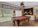Entertainment room with a pool table, unique decor, and sliding glass doors at 15053 Peace Blvd, Spring Hill, FL 34610