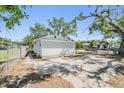 Spacious backyard with partial fencing and mature trees providing shade and privacy at 1540 7Th E Ave, Bradenton, FL 34208