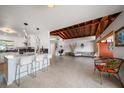 Open-concept living area showcasing a vaulted ceiling and seamless transition to other living spaces at 19 N Pine Cir, Belleair, FL 33756