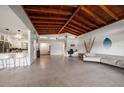 Open-concept living area with modern design, vaulted ceiling, and seamless transition to the kitchen at 19 N Pine Cir, Belleair, FL 33756