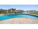 Backyard pool with brick border overlooking the water and waterfront property at 19 N Pine Cir, Belleair, FL 33756