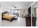 Spacious main bedroom featuring tile floors, a ceiling fan, and balcony access at 2413 Bayshore Blvd # 801, Tampa, FL 33629