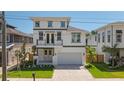Beautiful two-story home with a well-manicured front yard and a two-car garage at 3310 W Wyoming Ave, Tampa, FL 33611
