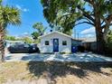 Charming single-story home with blue door, manicured lawn, and ample parking at 3498 13Th S Ave, St Petersburg, FL 33711