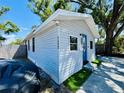 Charming single-story home with blue door, number address, and manicured lawn at 3498 13Th S Ave, St Petersburg, FL 33711