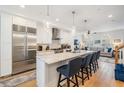Open kitchen with stainless steel appliances, marble countertops, and adjacent living area at 409 Regent N Ln, St Petersburg, FL 33701