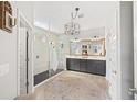 Spa-like bathroom with a large vanity, framed mirror, and an expansive glass-enclosed shower at 4108 Mellon Dr, Odessa, FL 33556