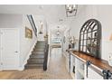 Bright foyer boasts wood-look tile flooring, a staircase with an iron banister, and decorative accents at 4108 Mellon Dr, Odessa, FL 33556