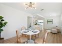 Cozy dining area with round table set for four with views to open concept kitchen and living area at 4675 26Th N Ave, St Petersburg, FL 33713