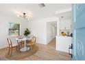 Bright dining area features a round table set, wood floors, and lots of natural light at 4675 26Th N Ave, St Petersburg, FL 33713
