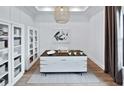 Stylish office with built-in shelves, modern desk, and natural light at 5958 Talon Preserve Dr, Nokomis, FL 34275