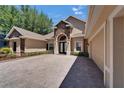 Home exterior with brick and lush landscaping at 607 Vintage Way, Brandon, FL 33511