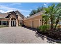 A three car garage with brick paver driveway at 607 Vintage Way, Brandon, FL 33511