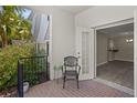Cozy patio with an outdoor chair and potted plants overlooking the interior of the home at 716 Lyndhurst St # 702, Dunedin, FL 34698