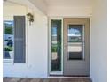 Inviting entryway featuring a decorative glass side panel, neutral door paint, and brick porch at 10036 40Th N St # 3, Pinellas Park, FL 33782