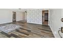 Open-concept living room featuring modern flooring, neutral color scheme, and a pass-through to the kitchen at 10036 40Th N St # 3, Pinellas Park, FL 33782