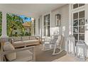Inviting front porch with comfortable seating, stylish décor, and relaxing ambiance, creating a perfect outdoor retreat at 147 & 139 Edgewater Dr, Dunedin, FL 34698