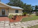 Close-up of the home's front yard highlighting the lovely landscaping and garden features at 1504 Swilley Rd, Plant City, FL 33567