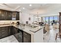 Open-concept kitchen featuring granite countertops, stainless steel appliances, and modern finishes at 15462 Gulf Blvd # 504, Madeira Beach, FL 33708