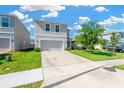 Two-story home featuring a clean gray facade, well-kept lawn, and a wide driveway leading to an attached two-car garage at 16149 Tuscany Hillside Rd, Odessa, FL 33556