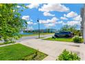 Nice street view with a pond and fountain, well-manicured green lawns, sidewalks and a parked SUV at 16149 Tuscany Hillside Rd, Odessa, FL 33556