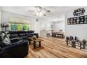 Bright living room with hardwood floors, a ceiling fan, and an adjacent dining area at 186 Grand Ave, Brooksville, FL 34604